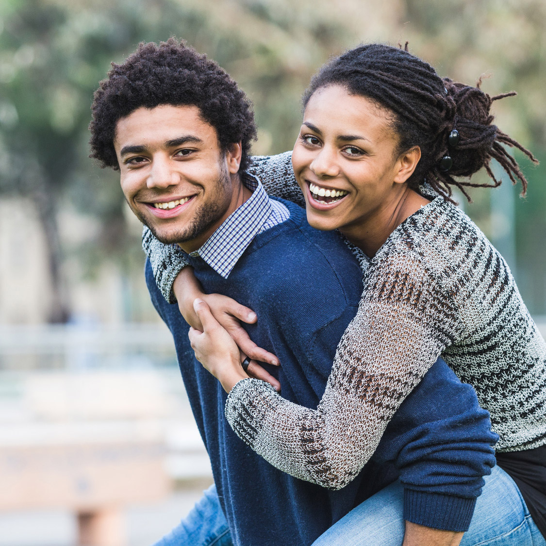 A woman piggy back riding her partner
